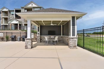 a patio with a table and chairs under a pavilion  at Aventura at Hawk Ridge, Lake St Louis, 63367